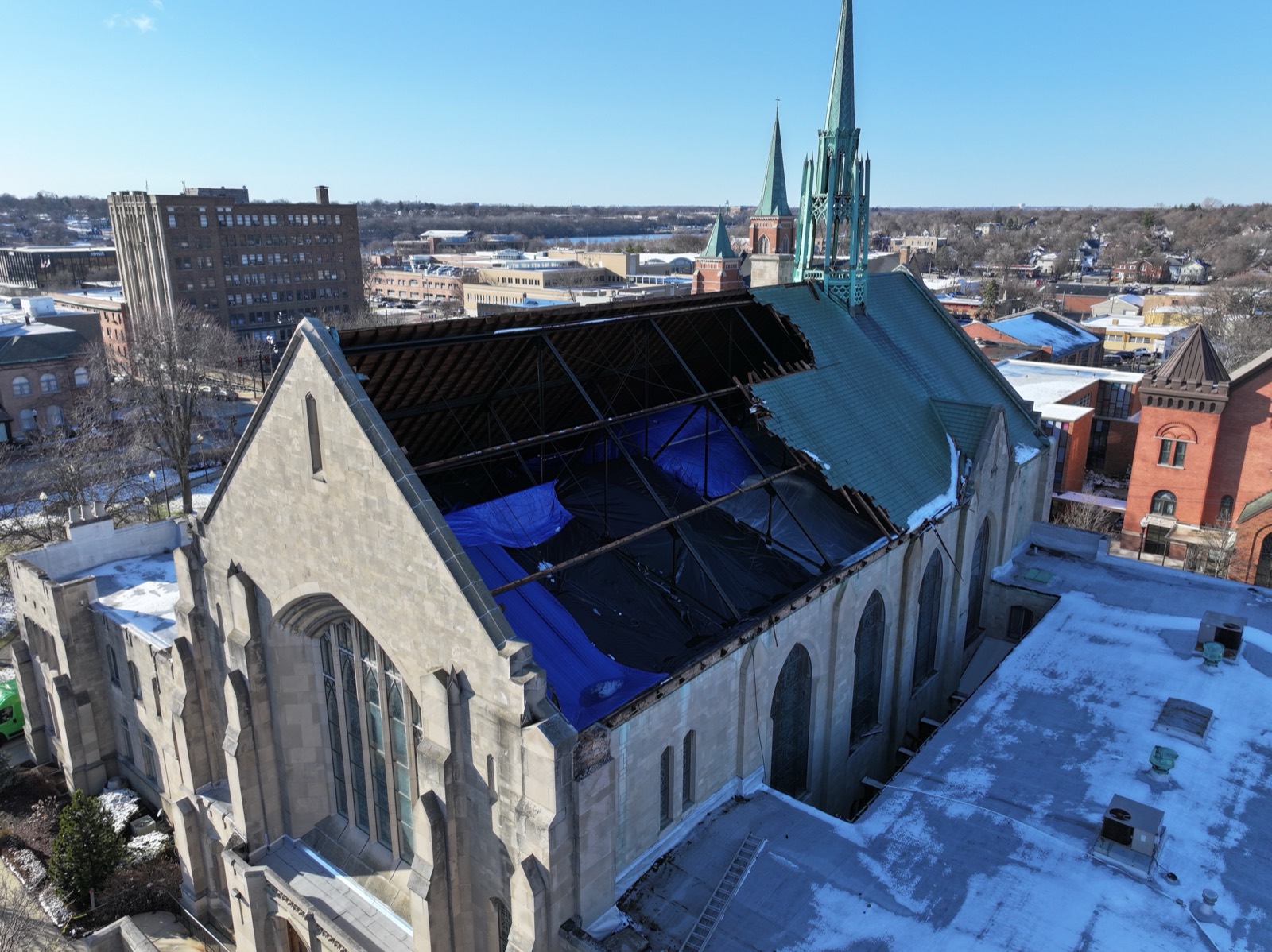 Historic church roof torn open and tarped after a hurricane