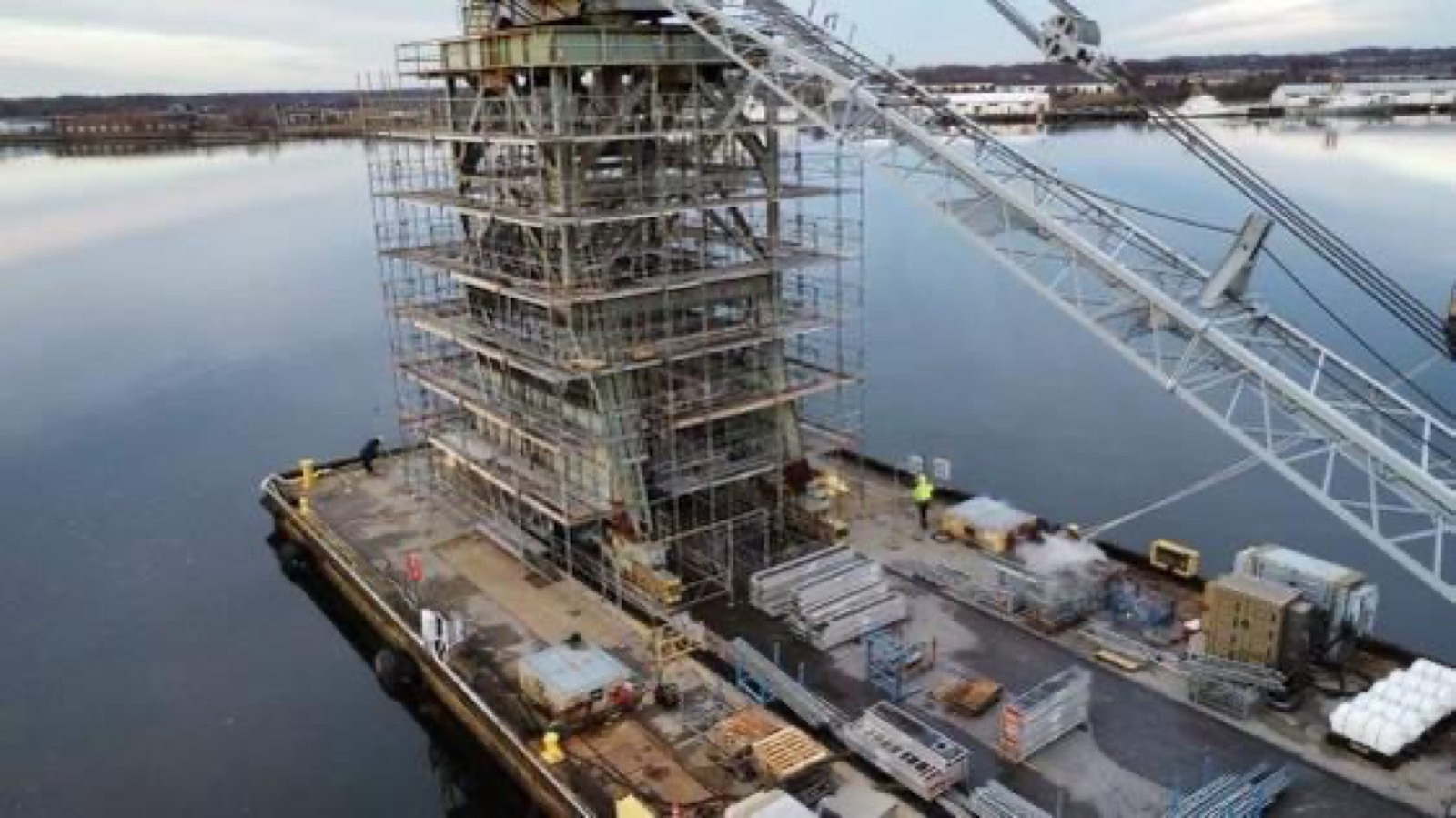 Government structure over water before Titanium Tarps, scaffolding going up