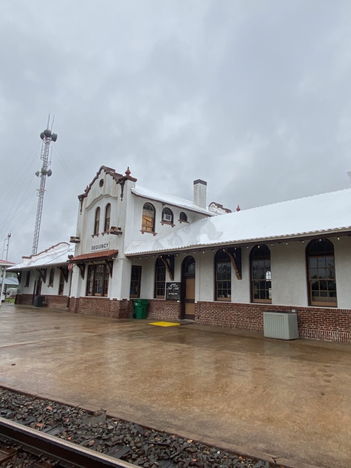 Historic DeQuincy Louisiana train depot with a white shrink wrapped roof