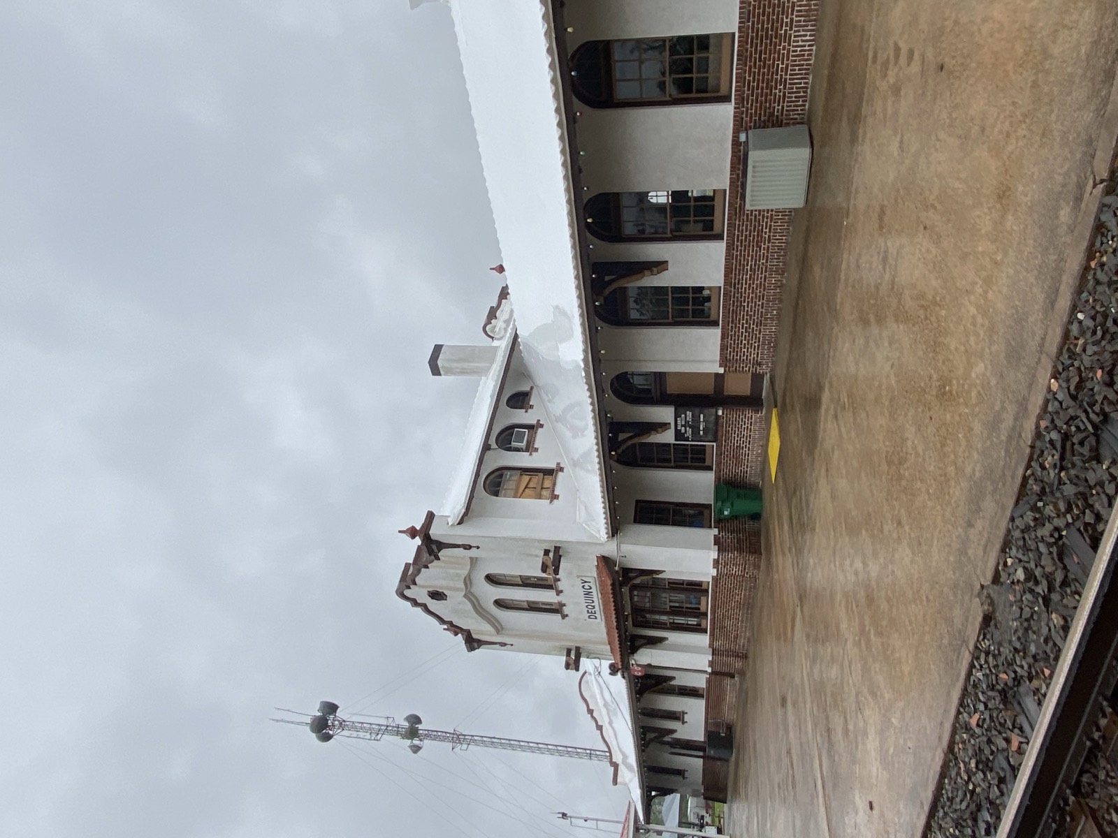 Historic train depot with a white shrink wrapped roof