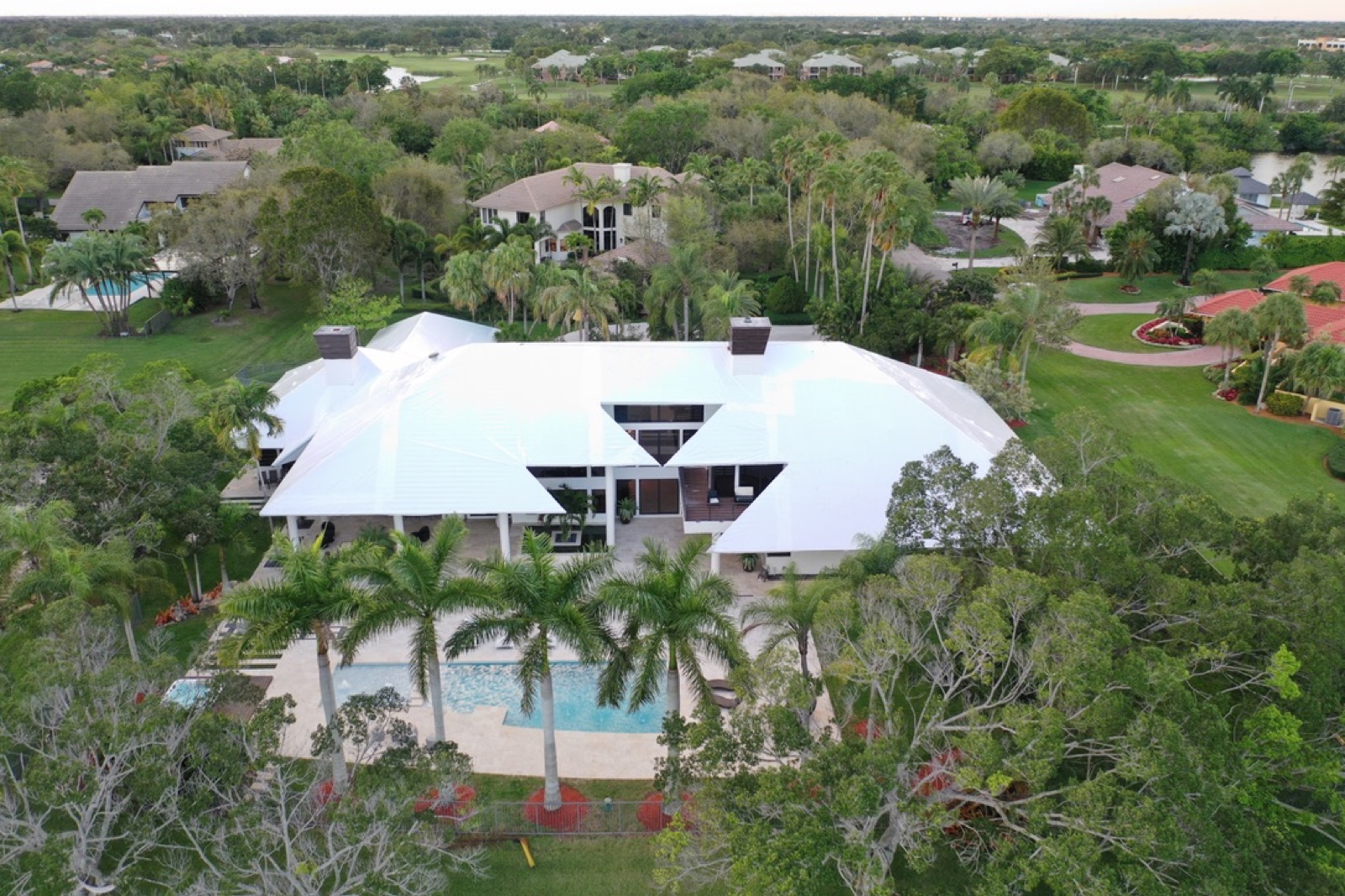 Luxury home and pool with a temporary shrink wrap roof cover