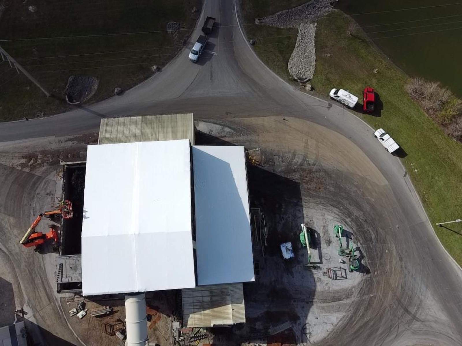 The same industrial plant sealed under a white Elastowrap membrane