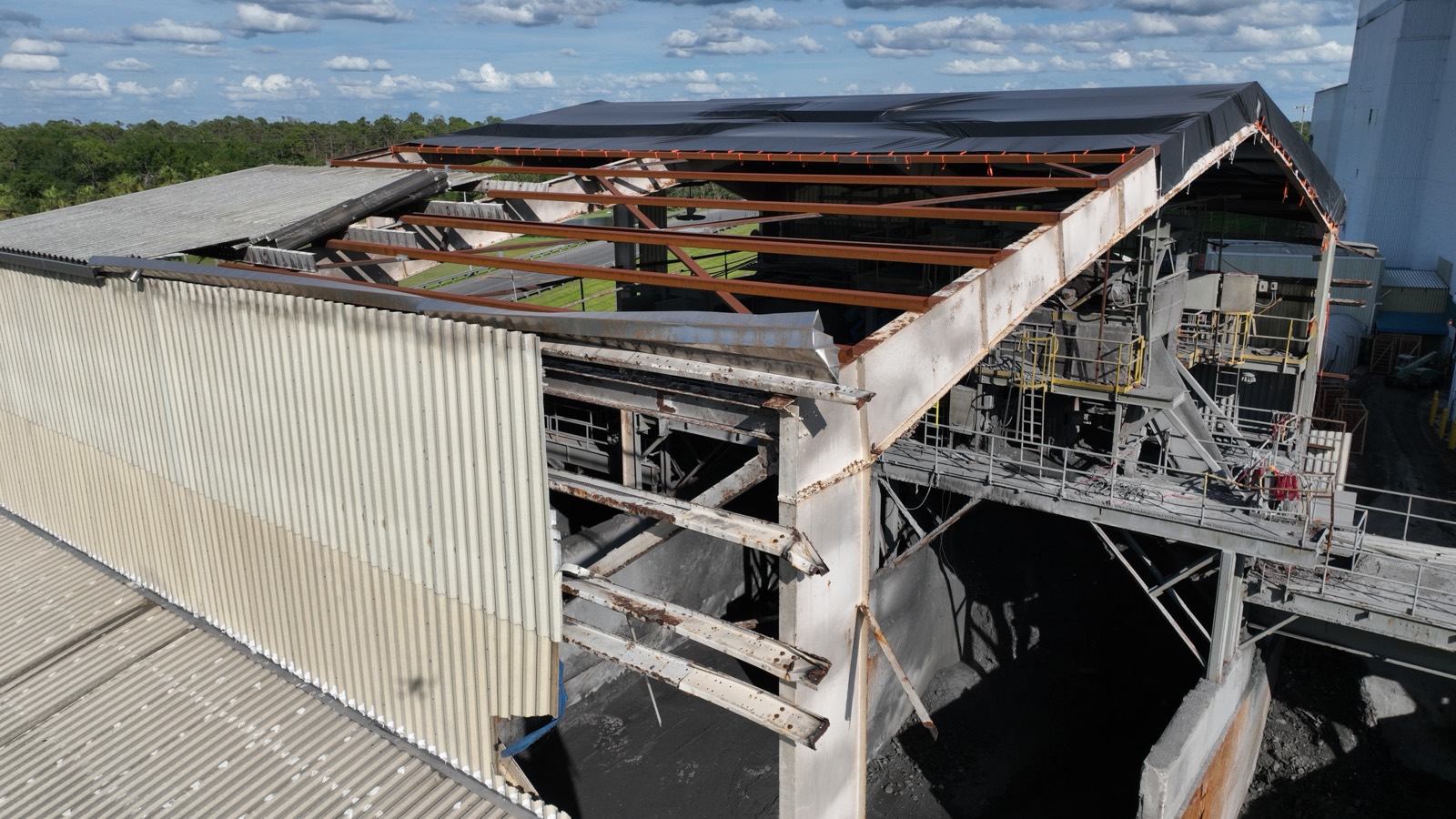 Industrial recycling plant with its roof structure torn open by a hurricane