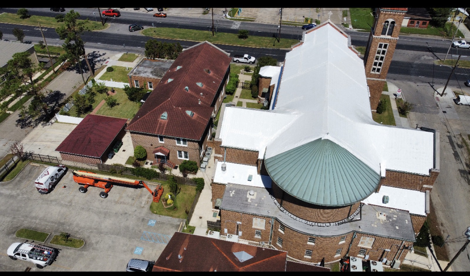 St. Agnes church with a white shrink wrapped roof after storm damage