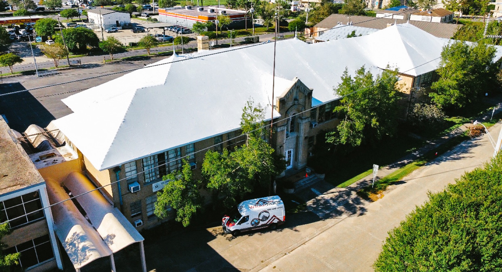 St. Christopher school sealed under a white Elastowrap roof