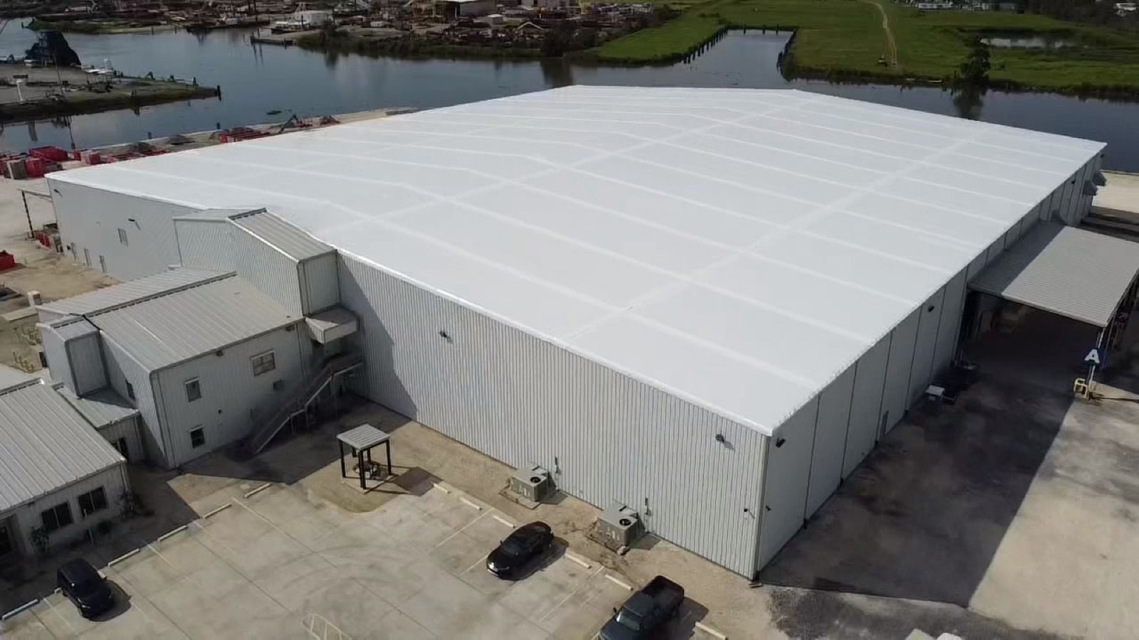 The finished warehouse sealed drum-tight under a white Elastowrap membrane