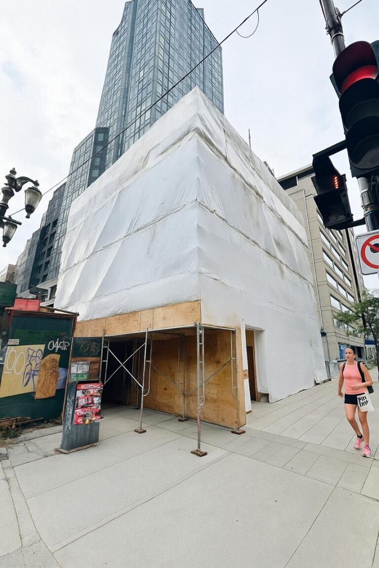 High-rise tower wrapped in Titanium Tarps enclosure film during construction
