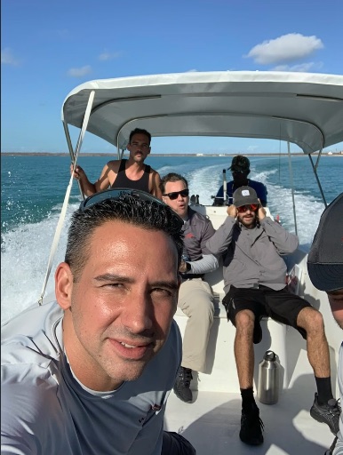 Titanium Tarps crew crossing open water by boat to reach a storm-hit island